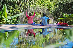 Asian woman and Asian man travel nature. Travel relax. Yoga posture concept, Good health care with yoga postures. Outdoor exercise