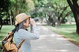 Asian woman backpack traveler take a photo when traveling at rain forest.Holiday vacation concept.journey lifestyle.solo travel.