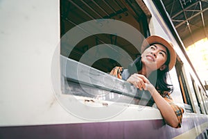 Asian woman backpacking starting traveling on train station background