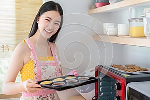 Asian woman Bake a cookies woman by oven