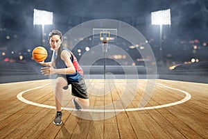 Asian woman basketball player in action with the ball