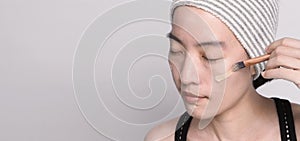 Asian woman beautiful face make up by foundation liquid