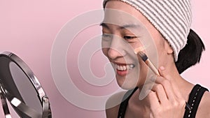 Asian woman beautiful face make up by foundation liquid