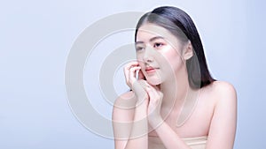 Asian woman beauty shot with half naked isolated on blue background with clean fresh skin