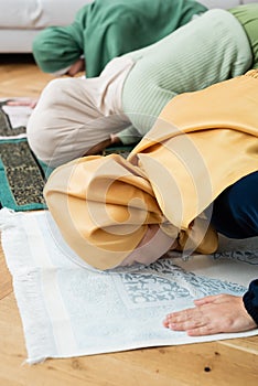 Asian woman bending while praying on