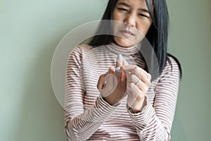 Asian woman with beriberi on hand or finger,Disease causing inflammation of the nerves