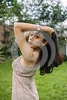 an Asian woman with black hair poses very sexily while wearing a nightgown