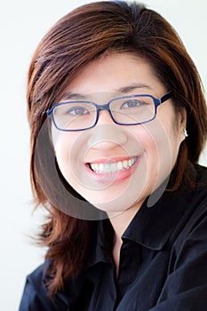 Asian woman in black shirt wearing glasses