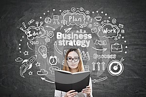 Asian woman with book and business strategy