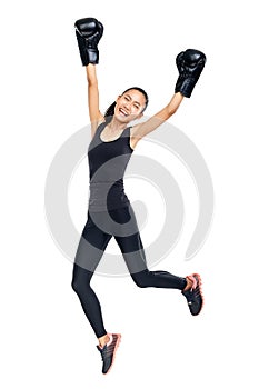 Asian woman in boxing gloves jumping in triumph of victory