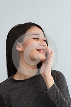 Asian woman braces. Teeth braces on the white teeth of women to equalize the teeth. Bracket system in smiling mouth, close up