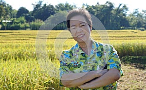 Asian woman in bright shirt at her SME farmland. Abstract own ag