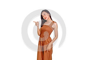 An Asian woman in brown tank top points her finger to the empty space