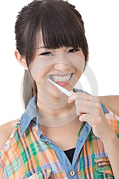 Asian woman brushing teeth