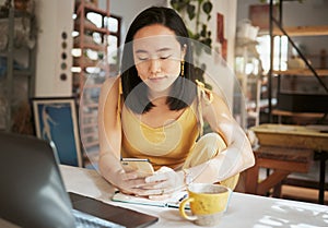 Asian woman, cafe and smartphone for connection, remote work and lady with online research, chatting and comfortable