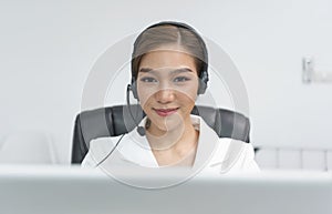 Asian woman Call center agent with headset working on support hotline in modern office