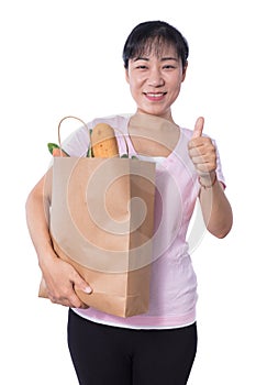 Asian Woman carrying shopping bag with groceries