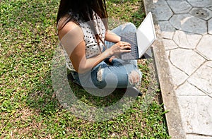 Asian woman with casual dress use tablet or in garden for work search or online shopping with wireless internet.