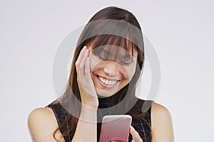 Asian woman, cellphone and happiness in studio for, social media, networking and smile. Gen z, female person and