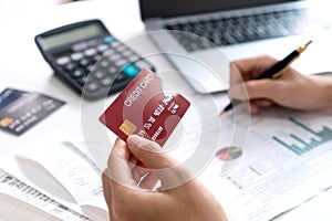 Asian woman checking bills  taxes  bank account balance and calculating credit card expenses. Family expenses concept. Close up