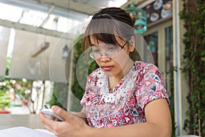 Asian woman checking her mails on smart phone