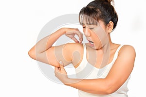 Asian woman checking her upper arm