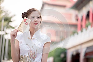 THE Asian woman in chinese dress holding couplet 'Happy' (Chine