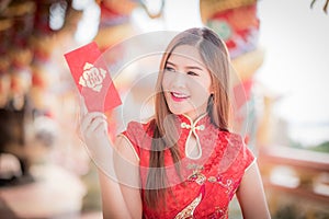 Asian woman in chinese dress holding couplet 'Happy' (Chinese w