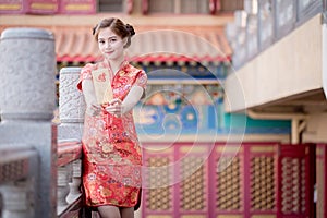 The Asian woman in chinese dress holding couplet 'Lucrative' (C