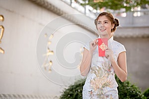 The Asian woman in chinese dress holding couplet 'Lucrative' (C