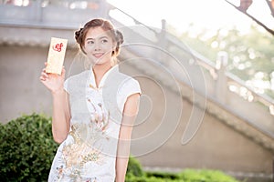 The Asian woman in chinese dress holding couplet 'Lucrative' (C