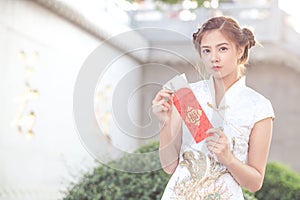 The Asian woman in chinese dress holding couplet 'Lucrative' (C