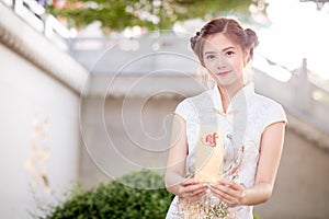 The Asian woman in chinese dress holding couplet 'Lucrative' (C