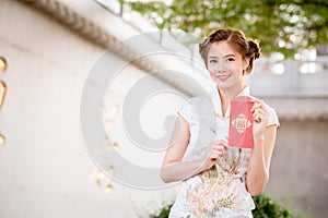 The Asian woman in chinese dress holding couplet 'Lucrative' (C