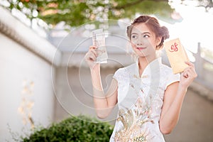 The Asian woman in chinese dress holding couplet 'Lucrative' (C