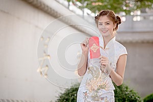 The Asian woman in chinese dress holding couplet 'Lucrative' (C