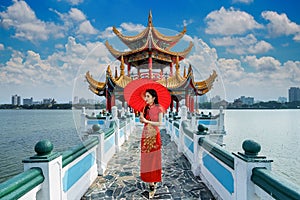 Asian woman in chinese dress traditional walking at Kaohsiung`s famous tourist attractions in Taiwan.