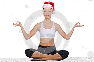 Asian woman in christmas hat with snow practicing yoga