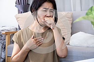 Asian woman with chronic coughing caused by heartburn from acid reflux