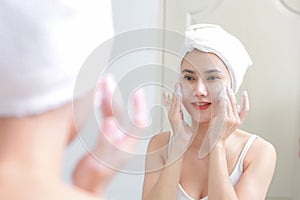 Asian woman cleaning face skin enjoy herself with bubble cleansing foam.