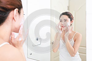 Asian woman cleaning face skin enjoy herself with bubble cleansing foam.