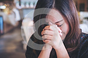 Asian woman close her eyes to praying and wishing for a good luck