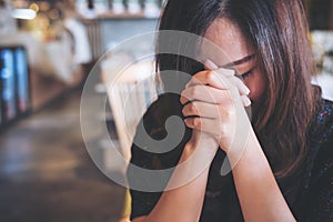 Asian woman close her eyes to praying and wishing for a good luck