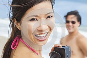 Asian Woman Couple at Beach Taking Video or Photograph