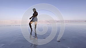 Asian woman dancing at the Dead Sea