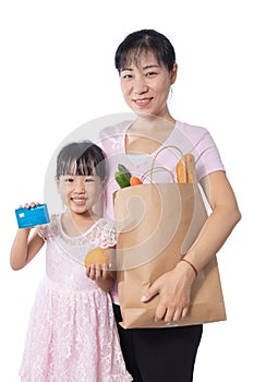 Asian Woman and daughter buying groceries with credit card