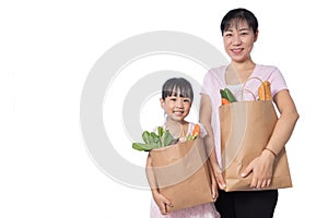 Asian Woman and daughter carrying groceries