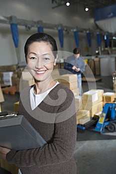 Asian Woman In Distribution Warehouse