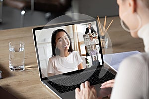 Asian woman and diverse colleagues taking part in group videocall photo