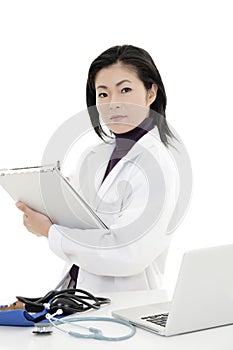 Asian woman Doctor or Nurse working at a desk holding a medical pad